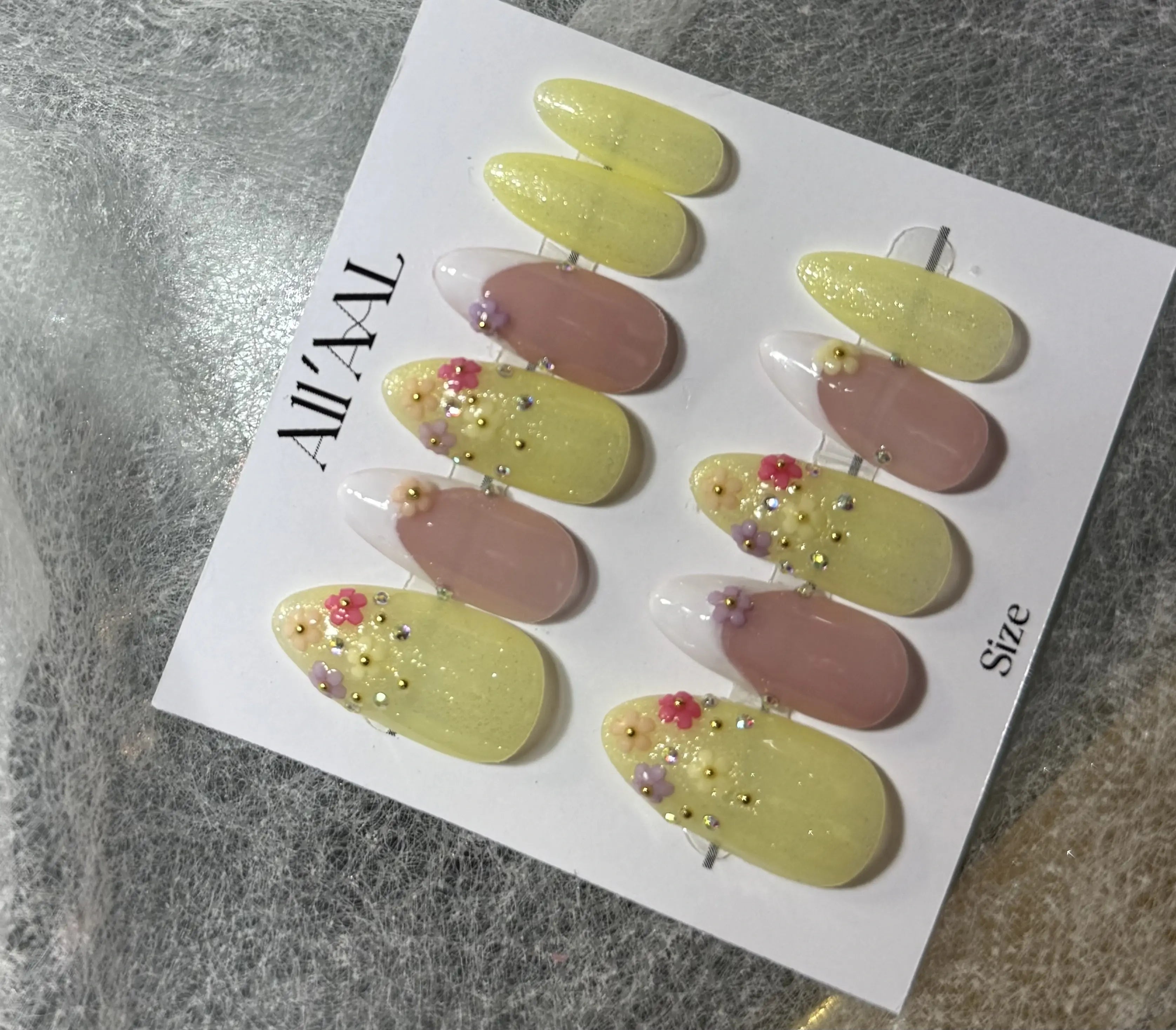 Set of decorative hair pins on a branded card with a gray surface background
