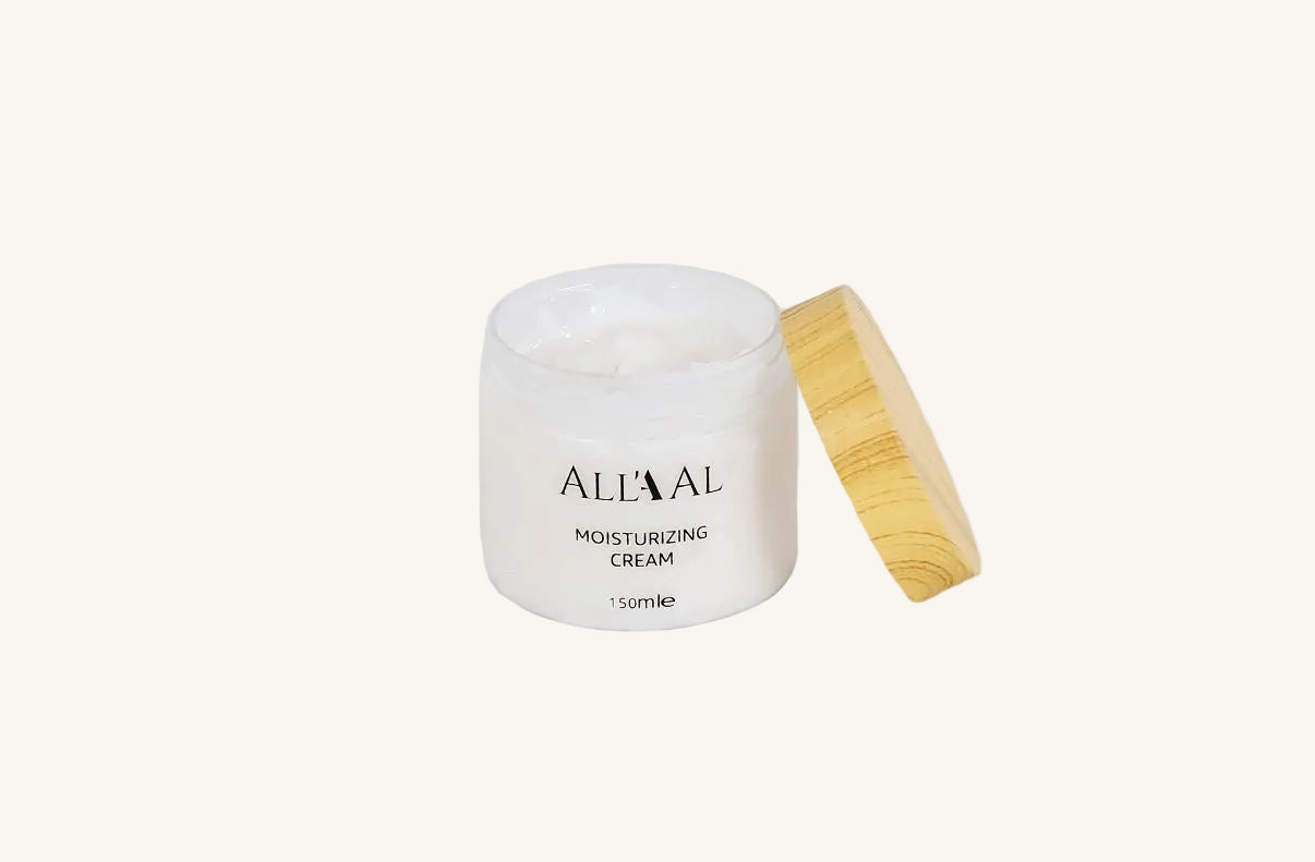 White jar of moisturizing cream with a wooden applicator on a white background